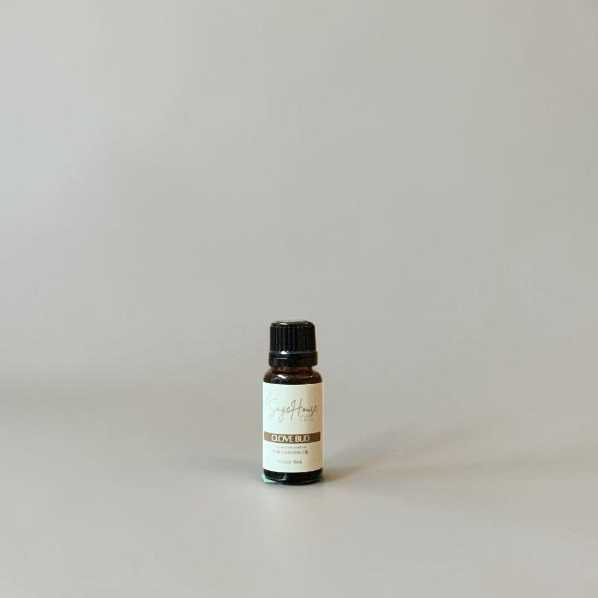 Bottle of Essential oil on a grey background.