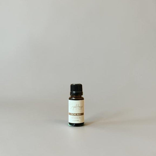 Bottle of Essential oil on a grey background.