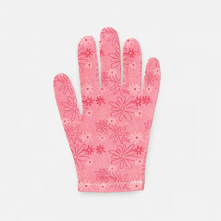 A pink floral-patterned moisturizing glove laid out on a white background.