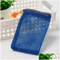 A Soap Scrub Pouch in blue, placed on a white surface. A basket and plant in the background.
