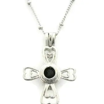 A silver cross shaped necklace with lava bead inside. on a silver chain