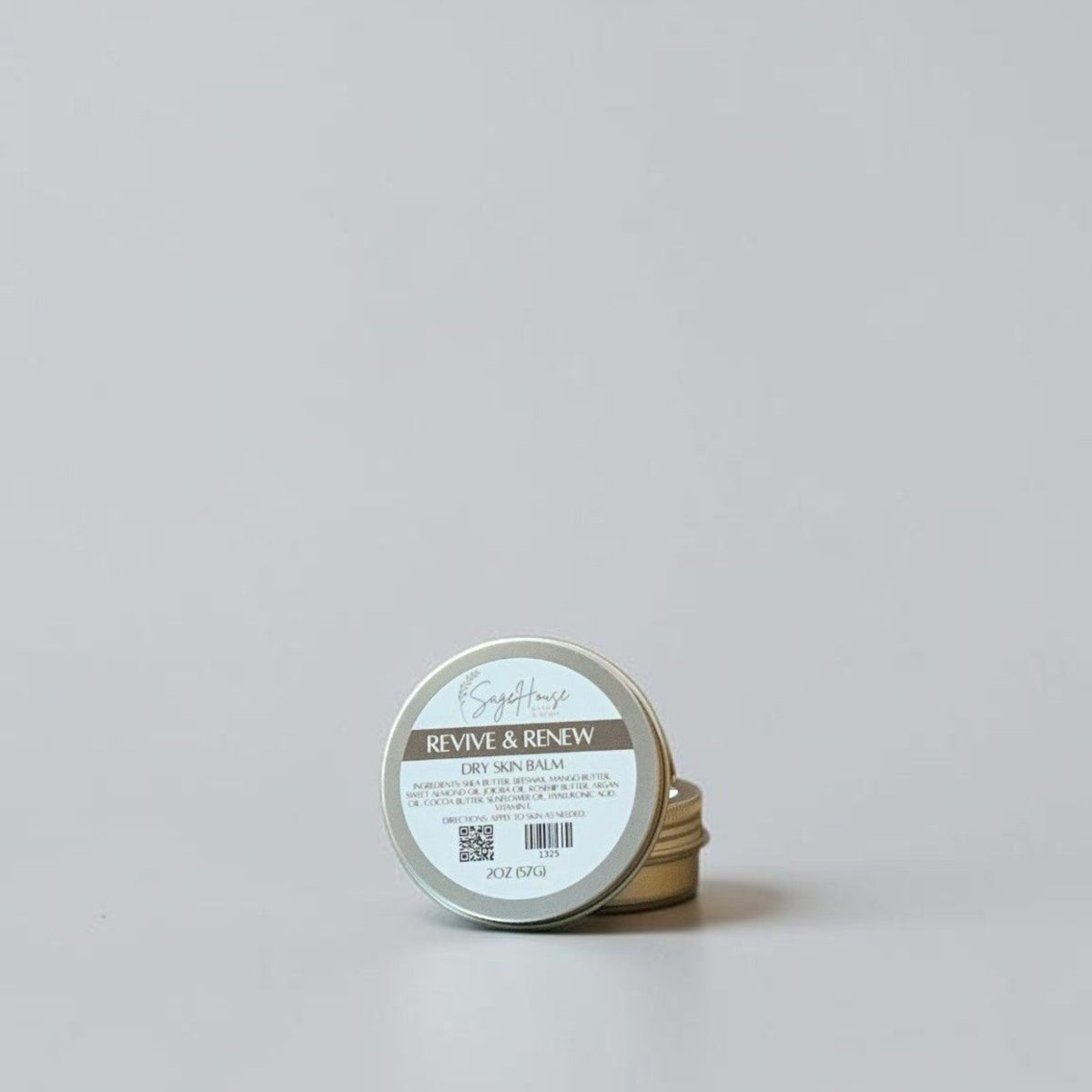 Small cylindrical container with a label on a light gray background