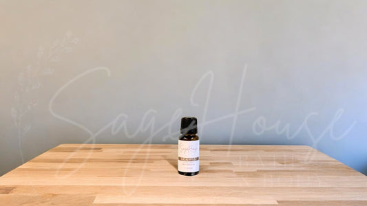A small bottle of eucalyptus globulus essential oil is placed on a wooden surface with a plain background.