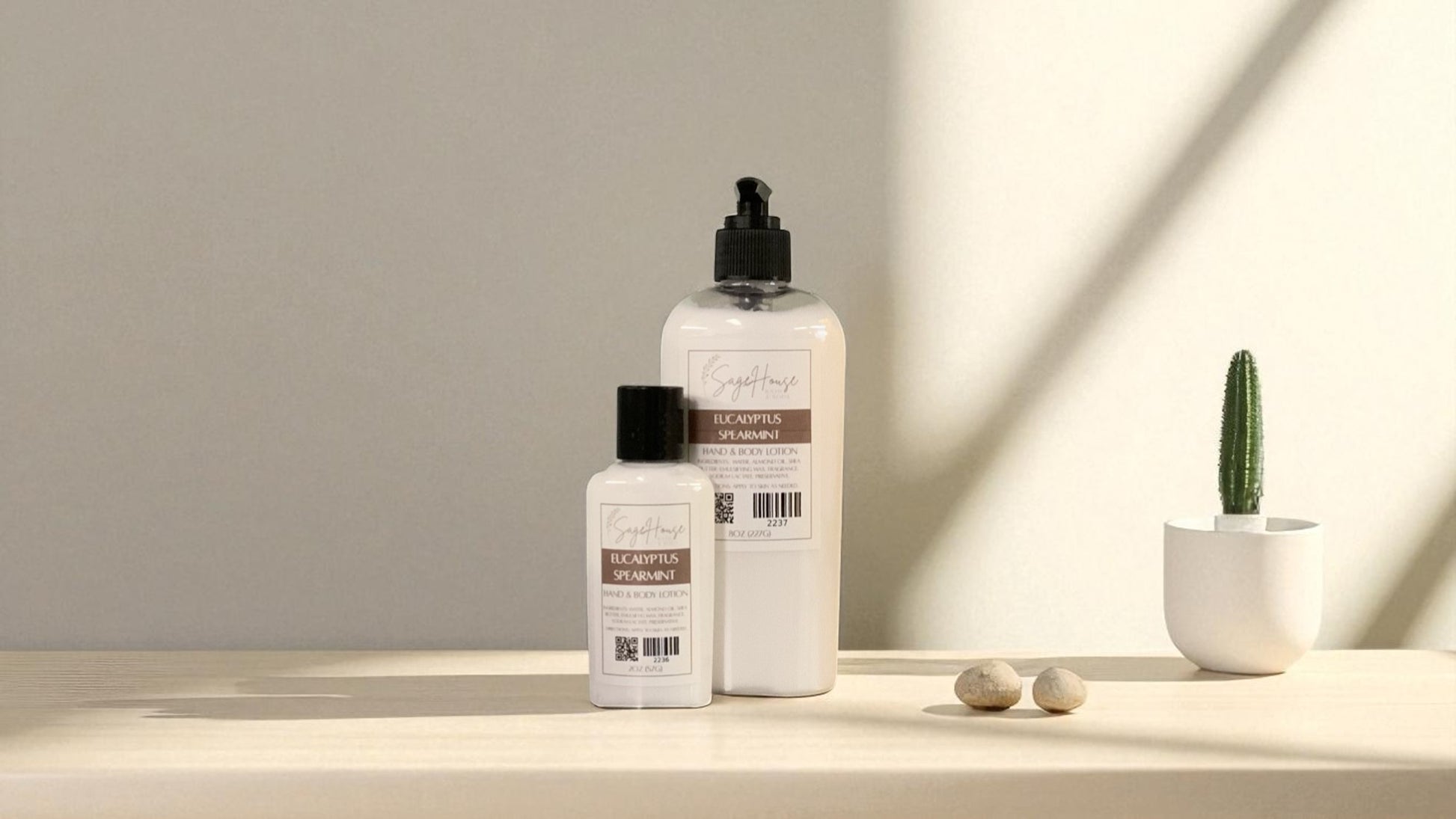 Two White bottles of lotion with black caps on a light wooden surface with a blurred white background