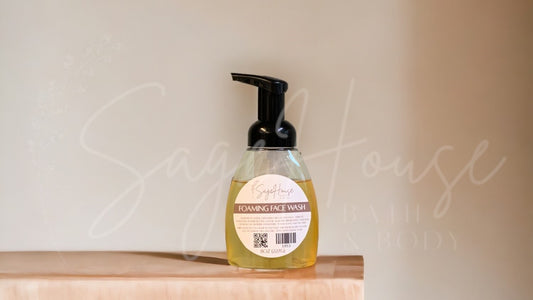 A clear plastic pump bottle containing yellow liquid, with a black pump dispenser, placed on a wooden surface against a neutral background.