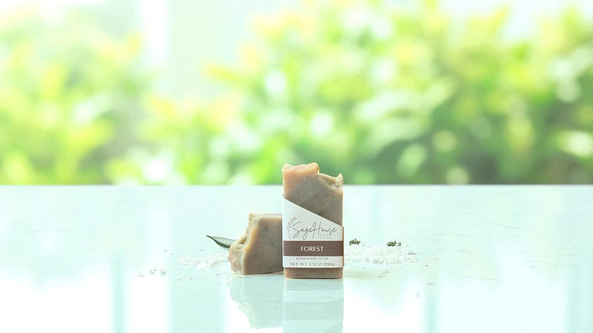 A bar of tan toned soap, on a white countertop with a blurred background