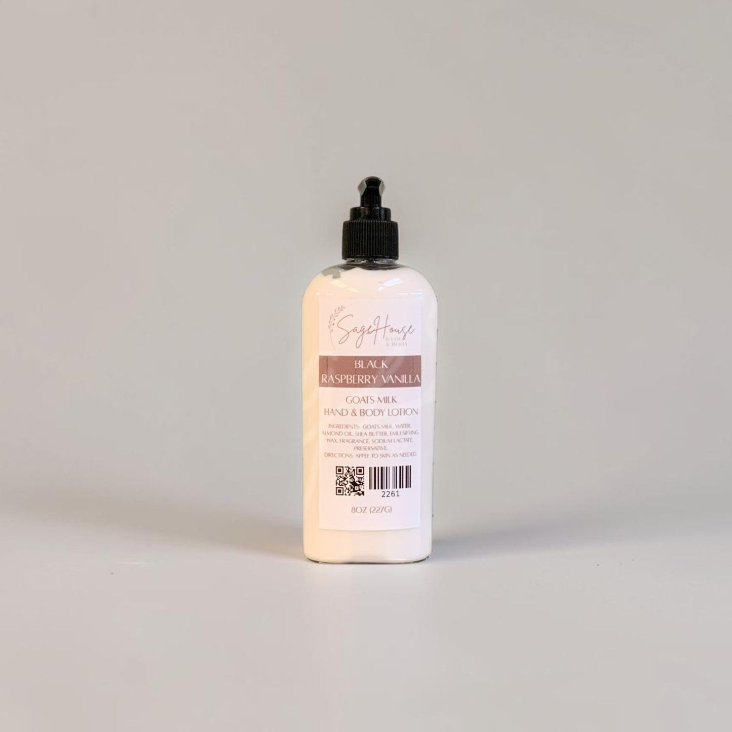 A large bottle of lotion with a black pump top and white label. Sitting on a white background.