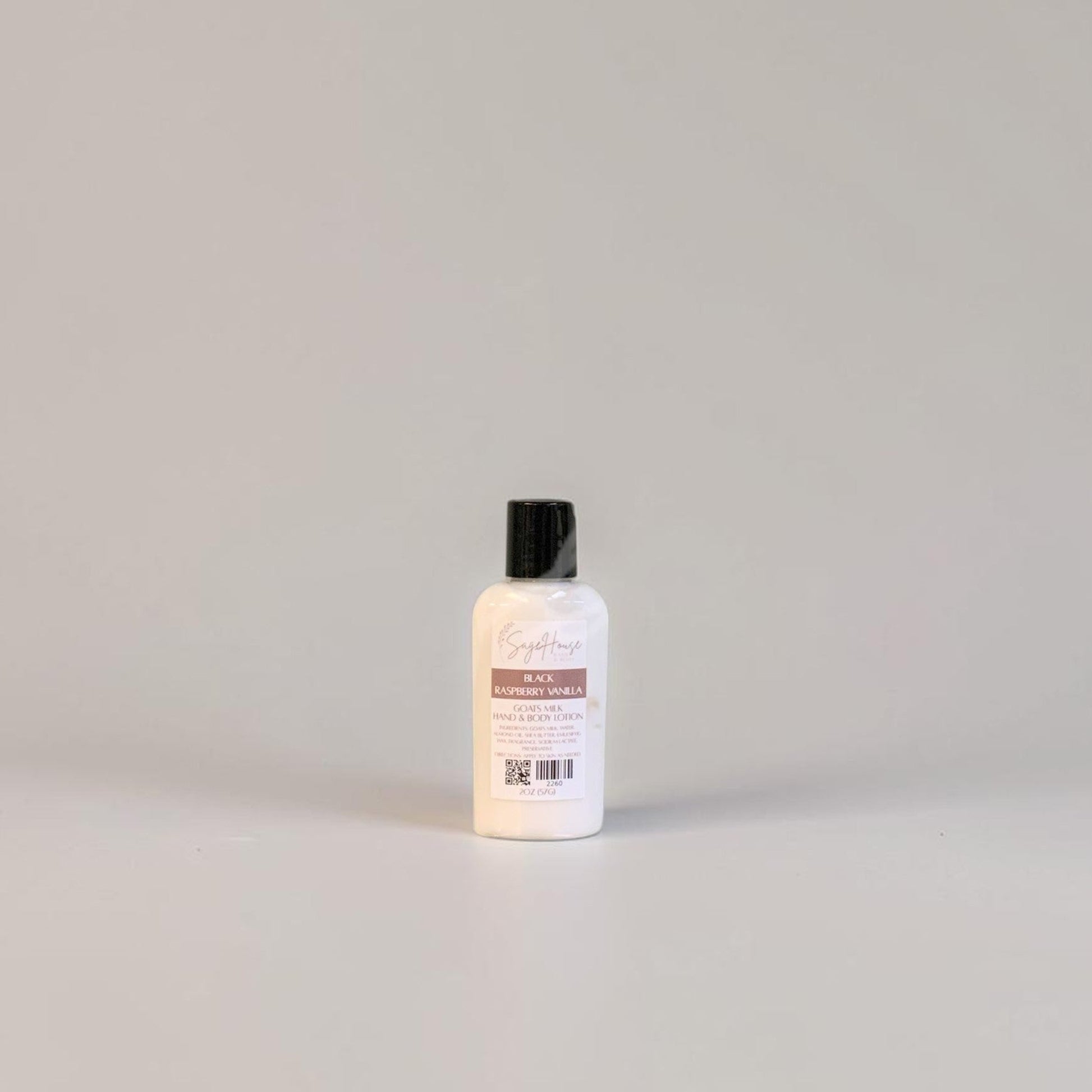 A small bottle of lotion with a black cap and white label. On a white background.