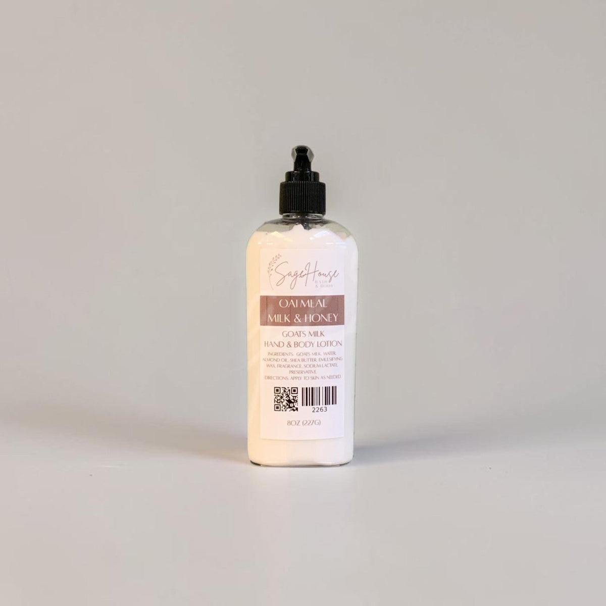 A large bottle of lotion with a black pump top and white label. On a white background.