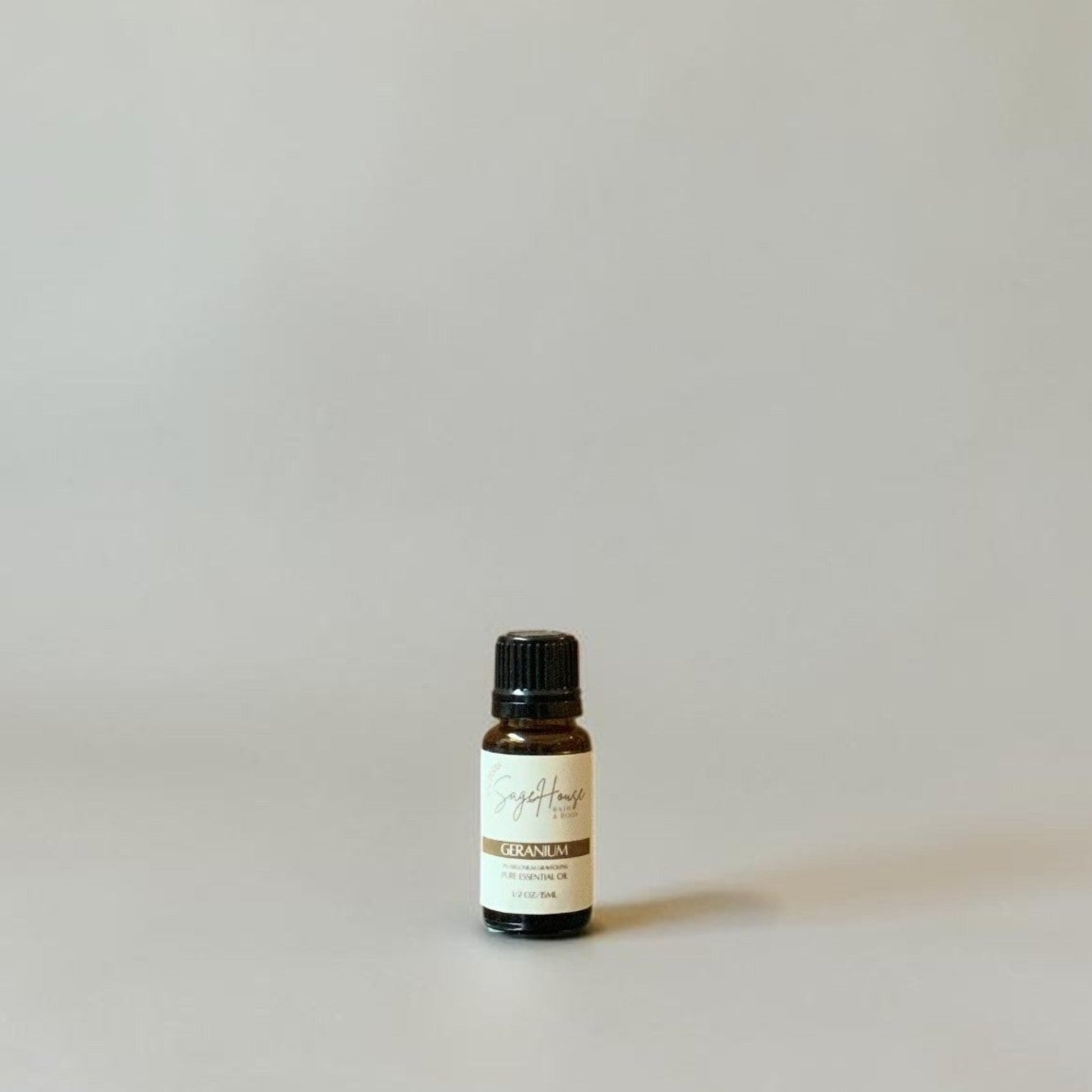 Bottle of Essential oil on a grey background.