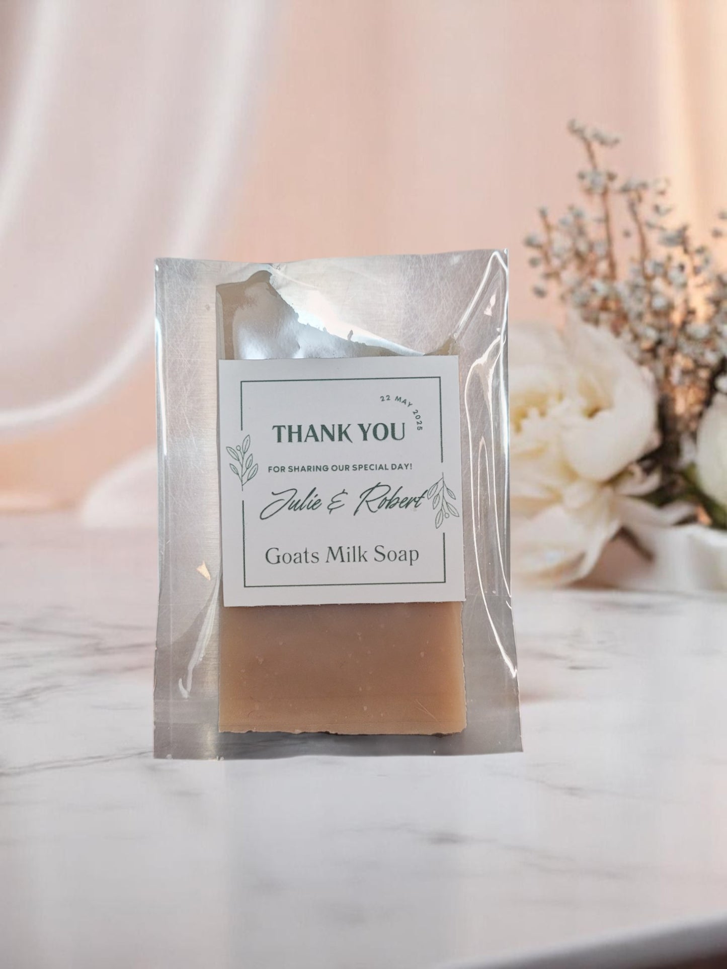Goats milk soap in a clear packaging with a 'Thank You' label on a soft background.