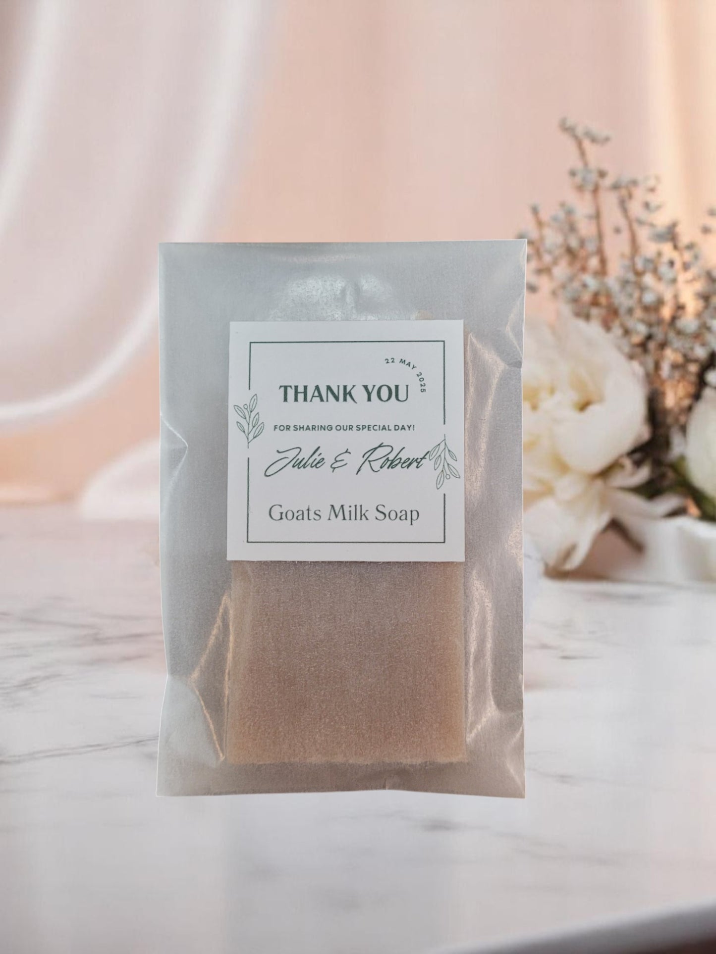 Goats milk sample soap in a frosted glassine packaging with a 'Thank You' label on a soft background.