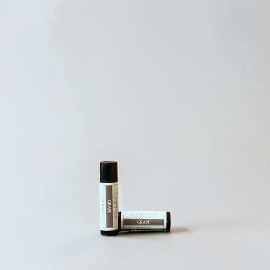 Two lip balm tubes on a light gray background