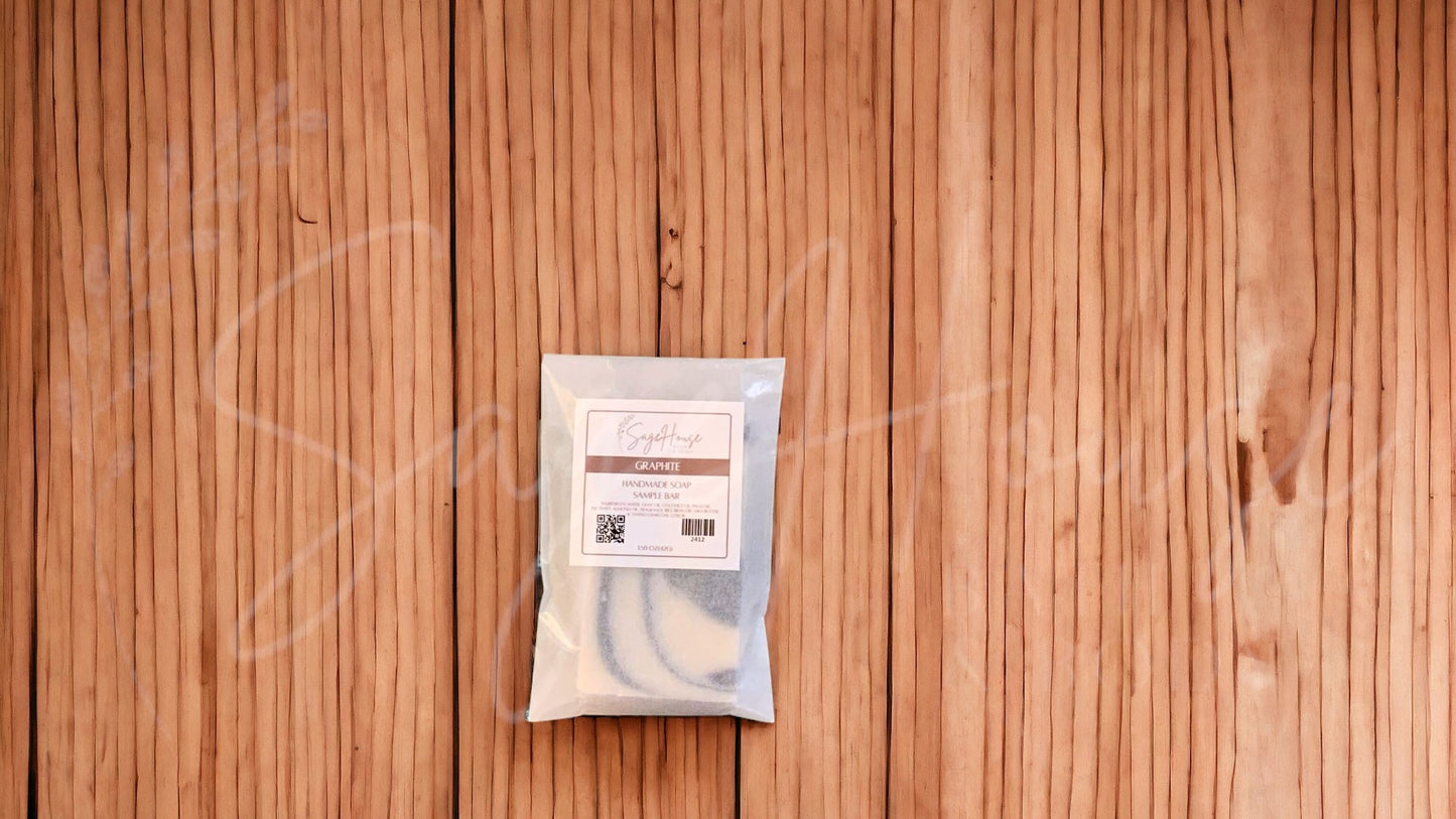 A sample bar of soap in a glassine bag. placed on a wood surface.