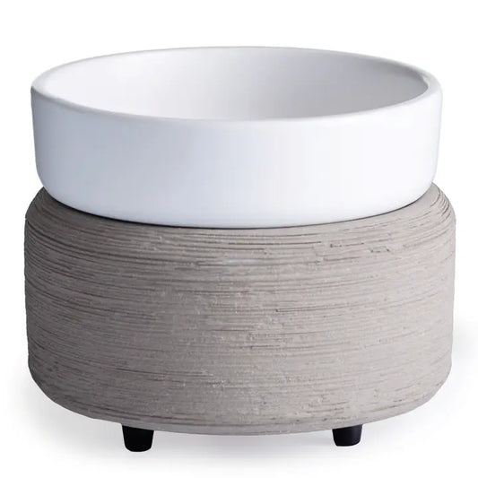 White ceramic bowl on a textured gray base with black feet against a white background