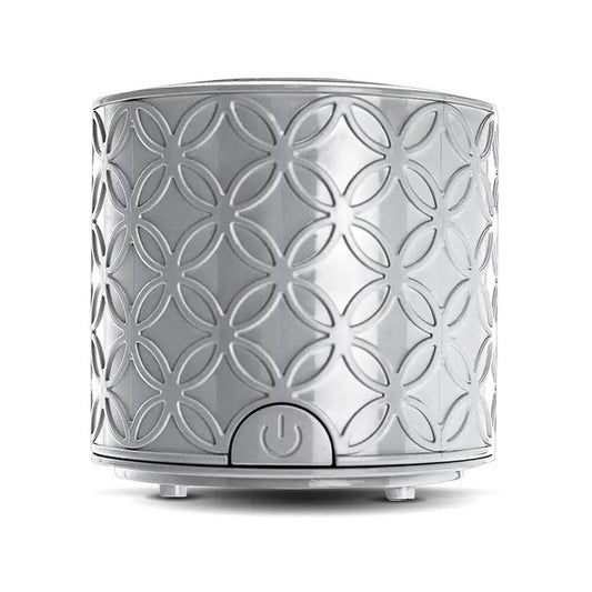 A gray, solid-patterned La Brisa diffuser designed to operate without a water reservoir, featuring a power button and used with essential oil pads.