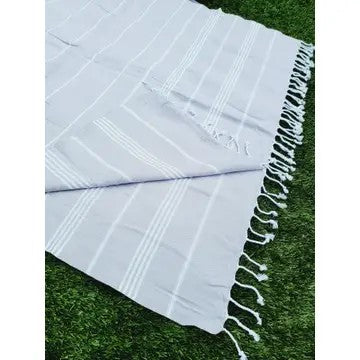 Gray Turkish cotton towel, folded onto itself, on a white background.