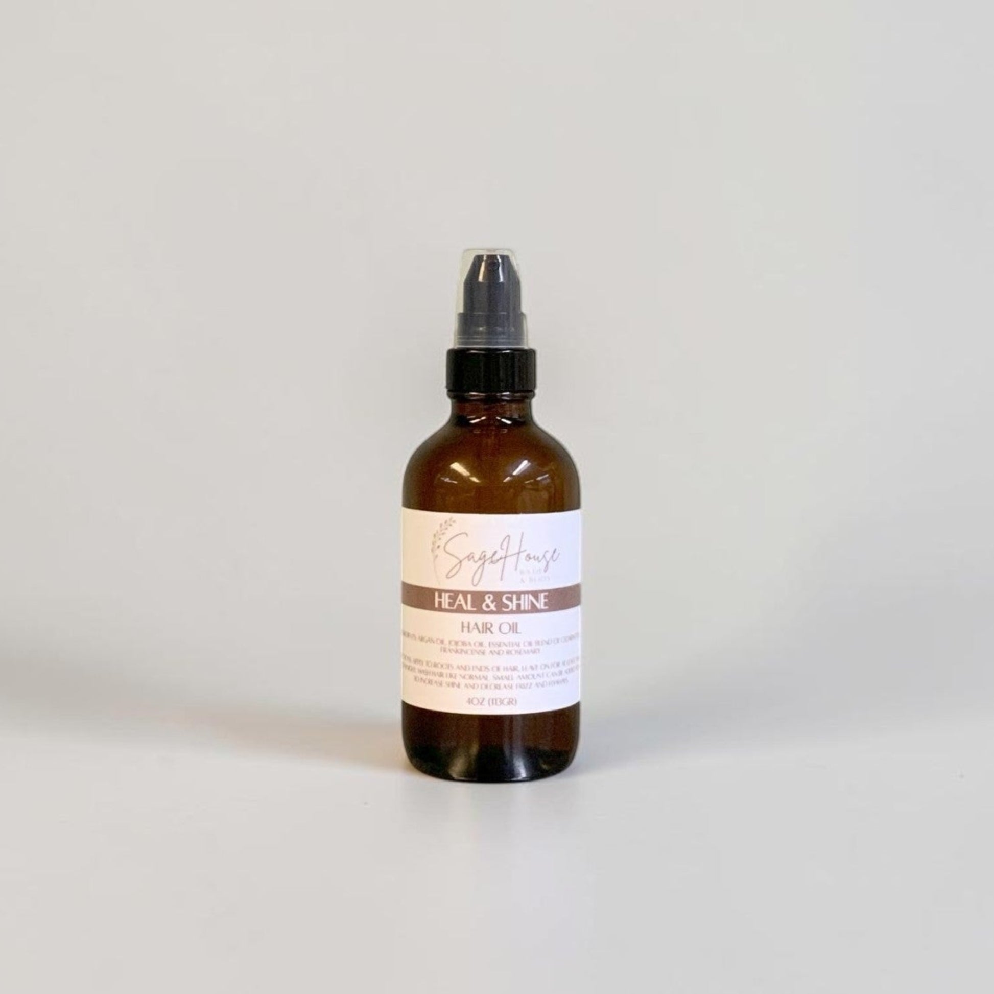 An amber glass dropper bottle with a black cap and a white label on a light gray background.