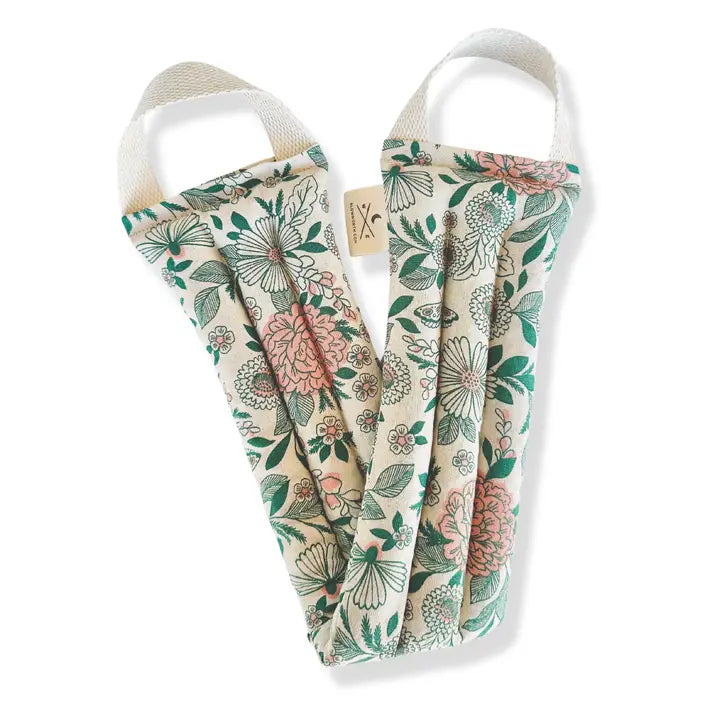 A neck wrap therapy pack with a floral pattern in neutral colors of green, pink & beige. displayed on a white background.