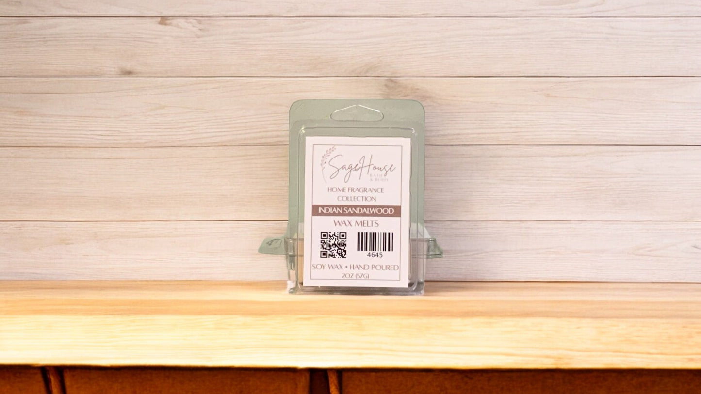 A clear clamshell container holding 6 wax melt cubes with a label on top, placed on a wooden surface against a wooden background.