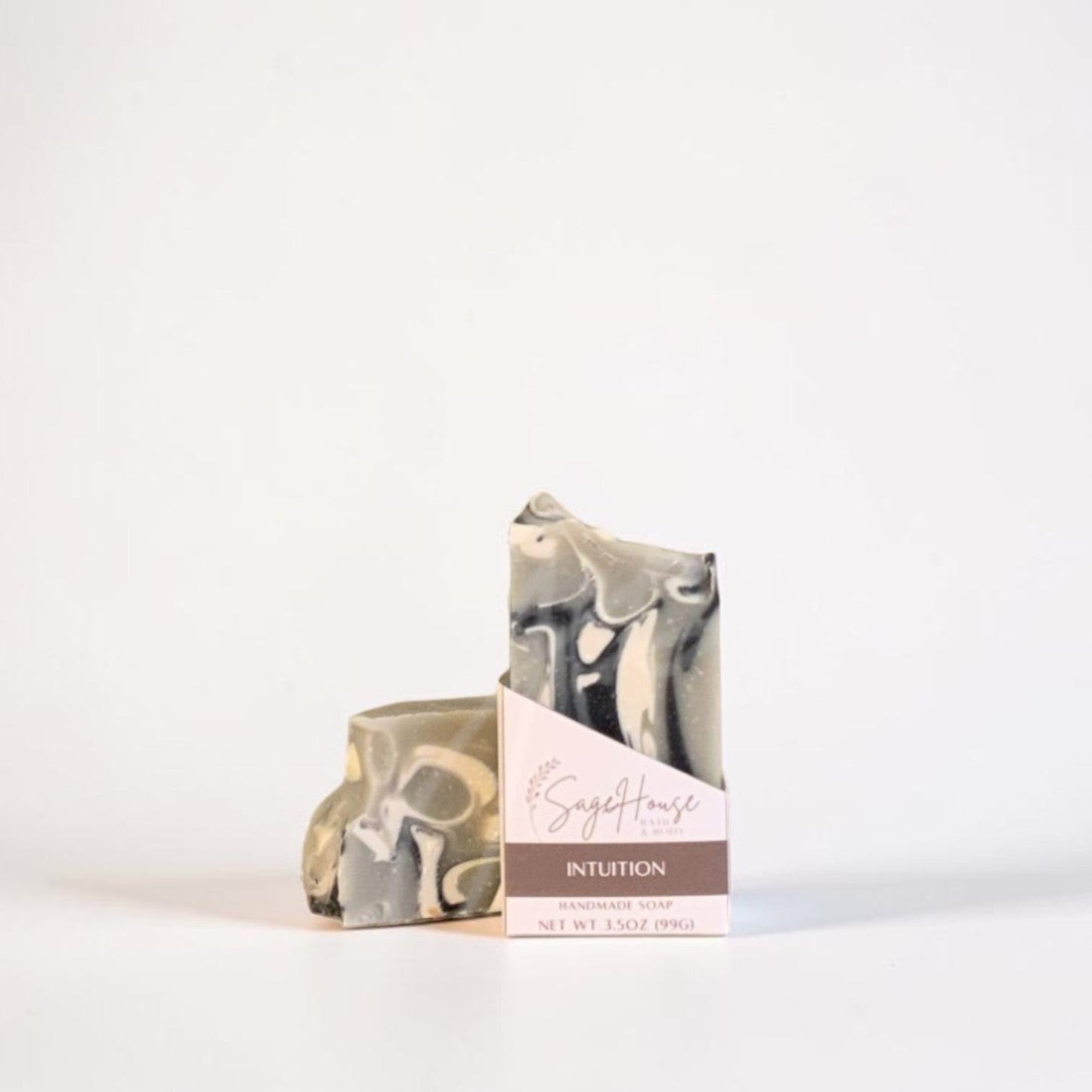 A labeled bar of soap sitting in front of a matching bar. On a white background.