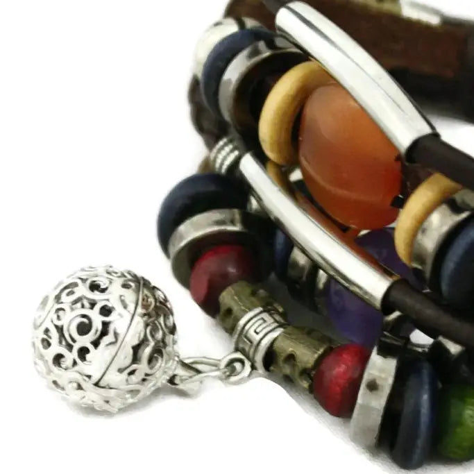 bracelet with black leather and silver, red, orange, green, blue & black beaded accents. lava bead inside of silver ball