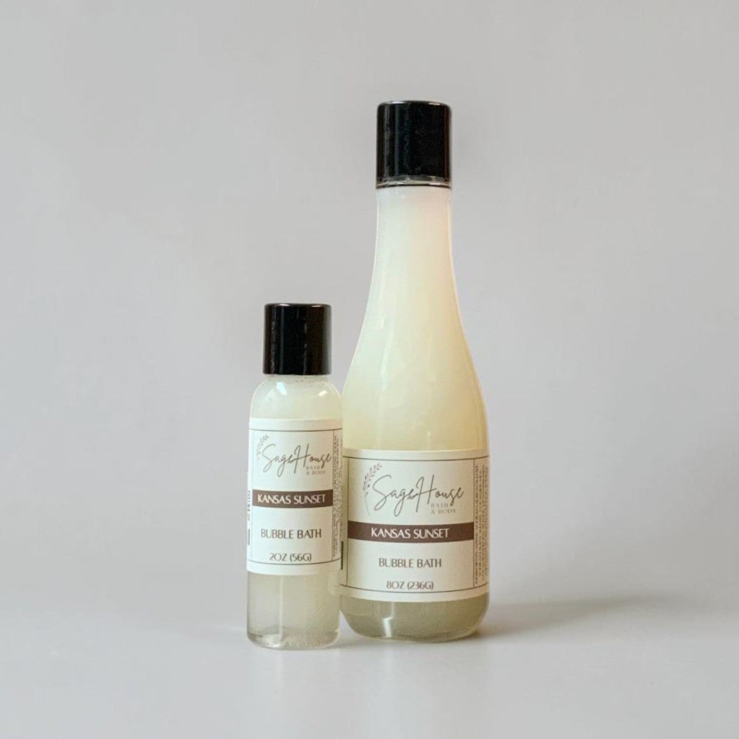 Two bottles of bubble bath on a light gray background