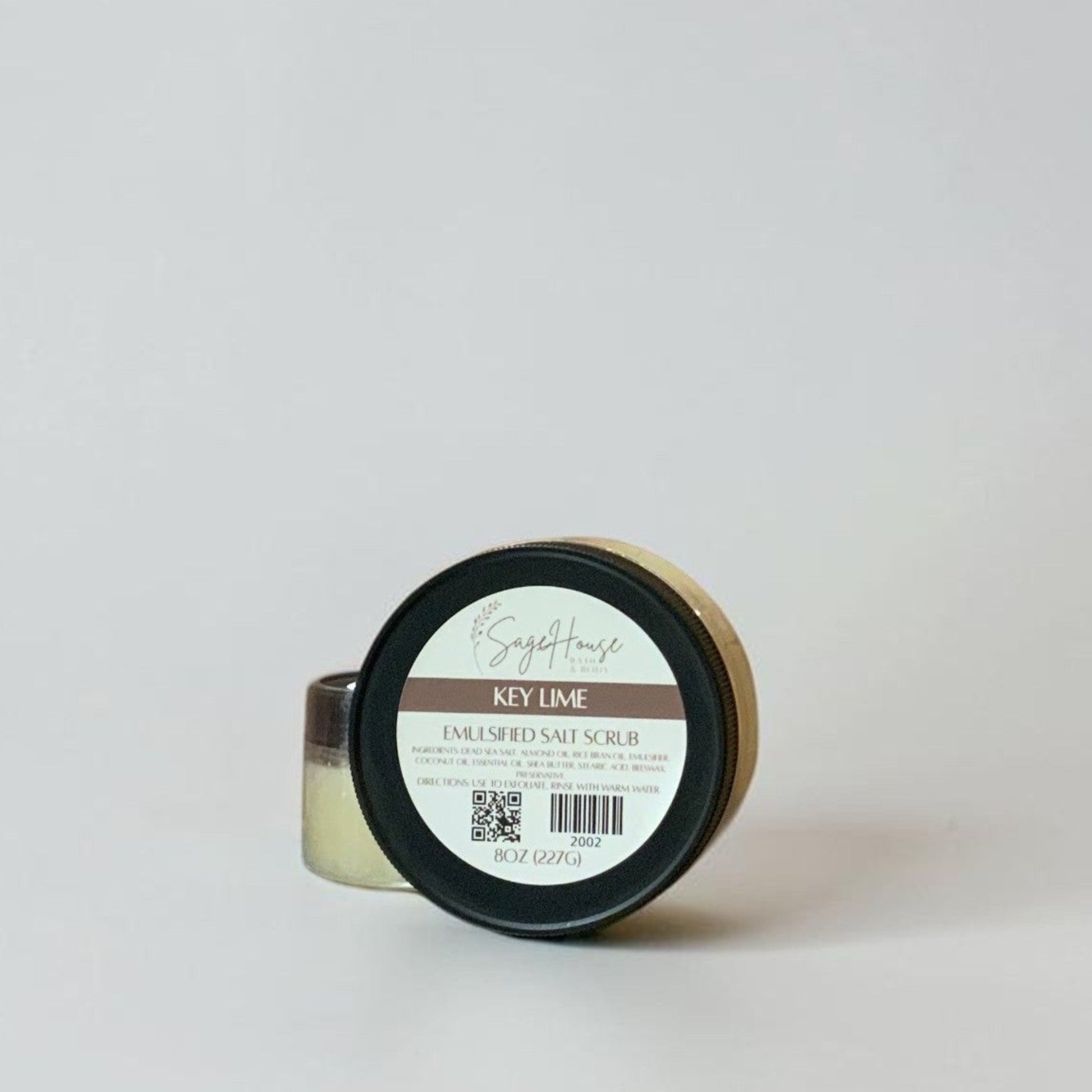2 jars of scrub with label, on a grey background.