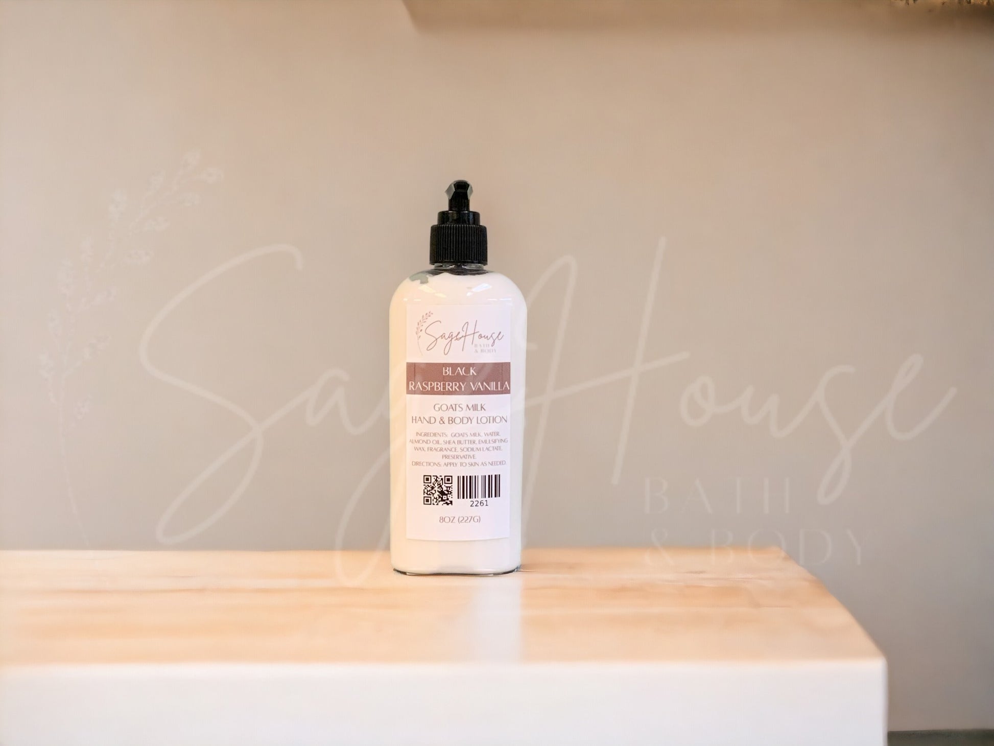 A Large bottle of lotion with black pump top, on a wooden surface with a neutral background