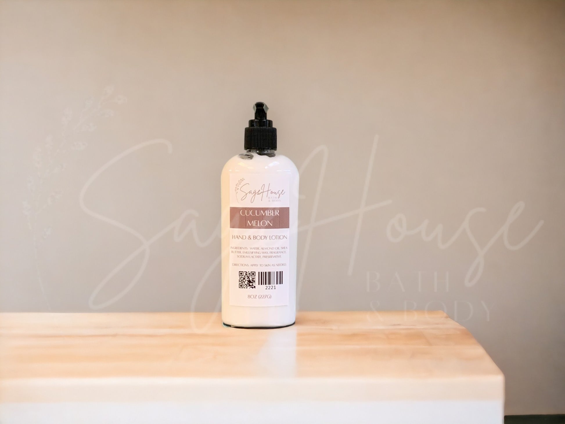A Large bottle of lotion with black pump top, on a wooden surface with a neutral background