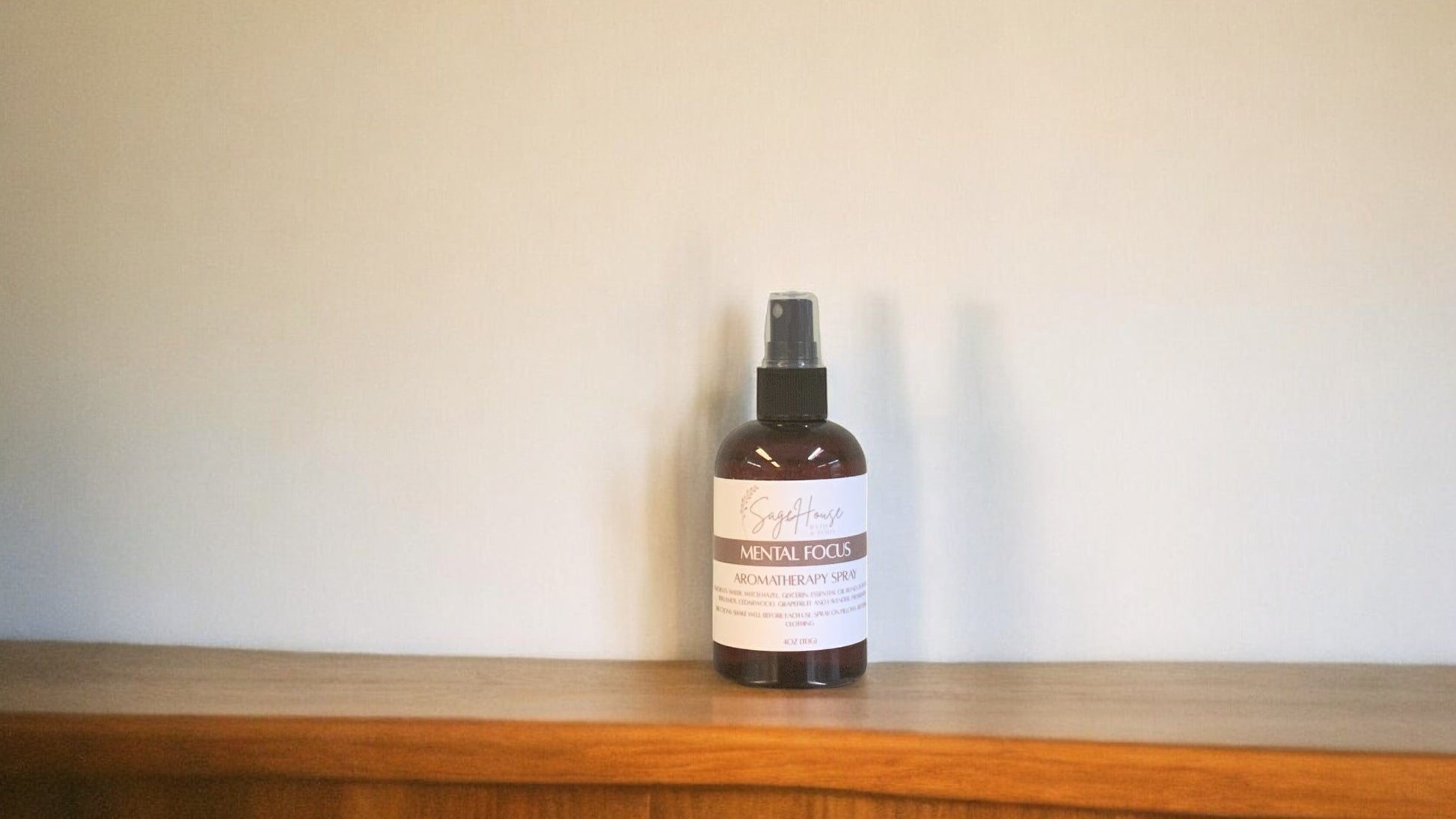 Amber colored spritz bottle with mental focus label, on wood surface.