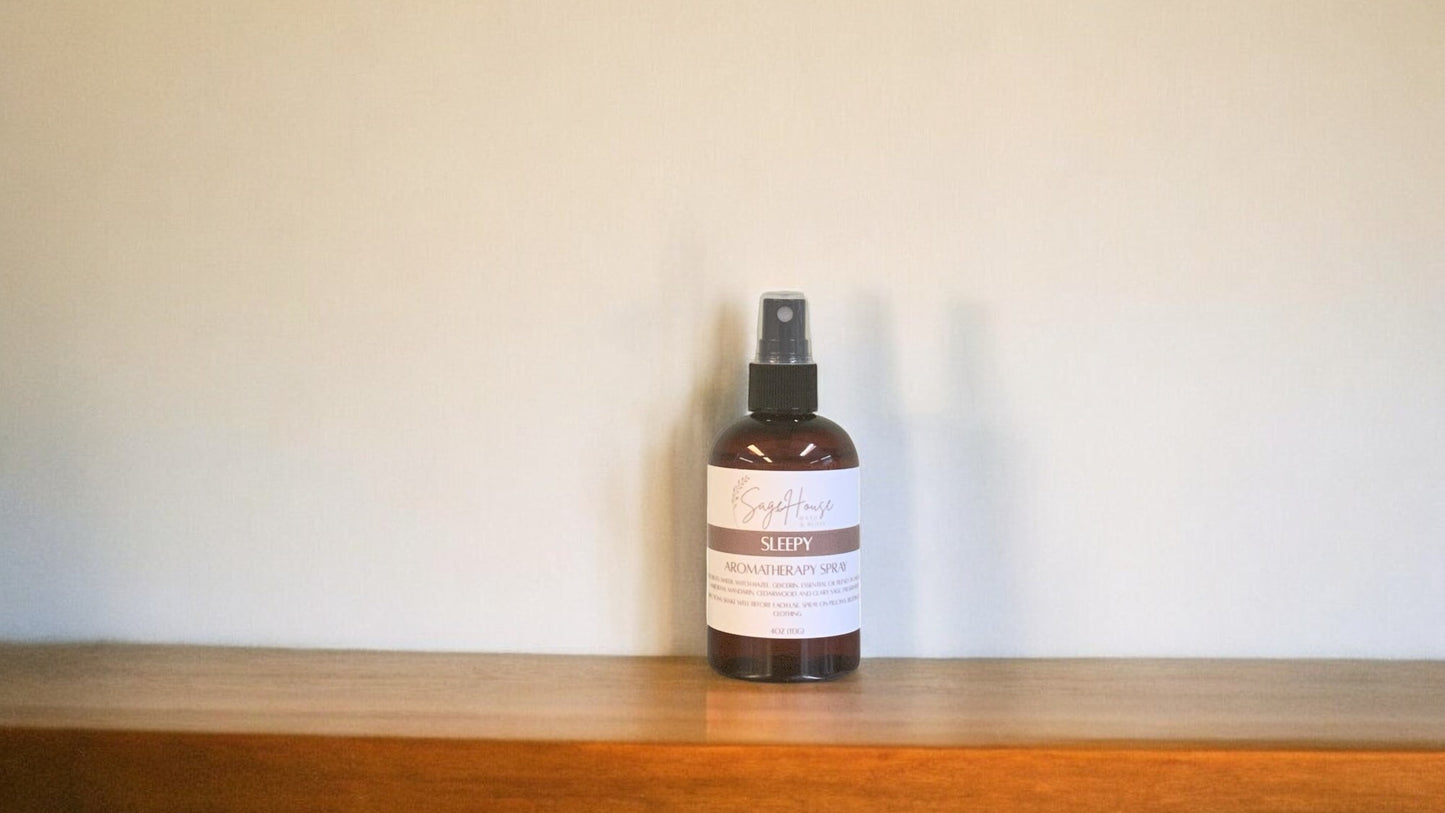 Amber colored spritz bottle with sleepy label, on wood surface.