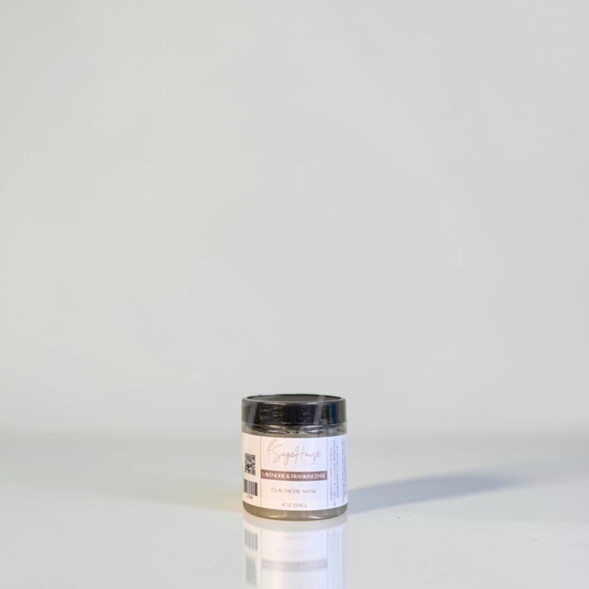 A jar with black lid and white label. On a white background.