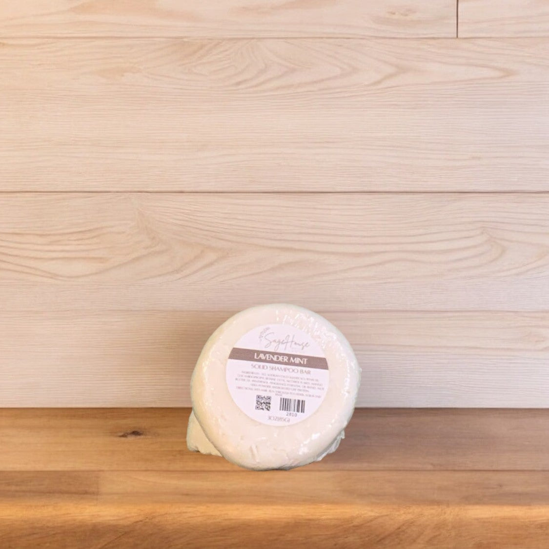 A Lavender Mint shampoo bar on a wooden surface.