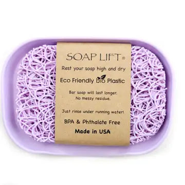 Lavender colored soap dish with soap lift sitting inside. Soap lift sold seperately. On a white background