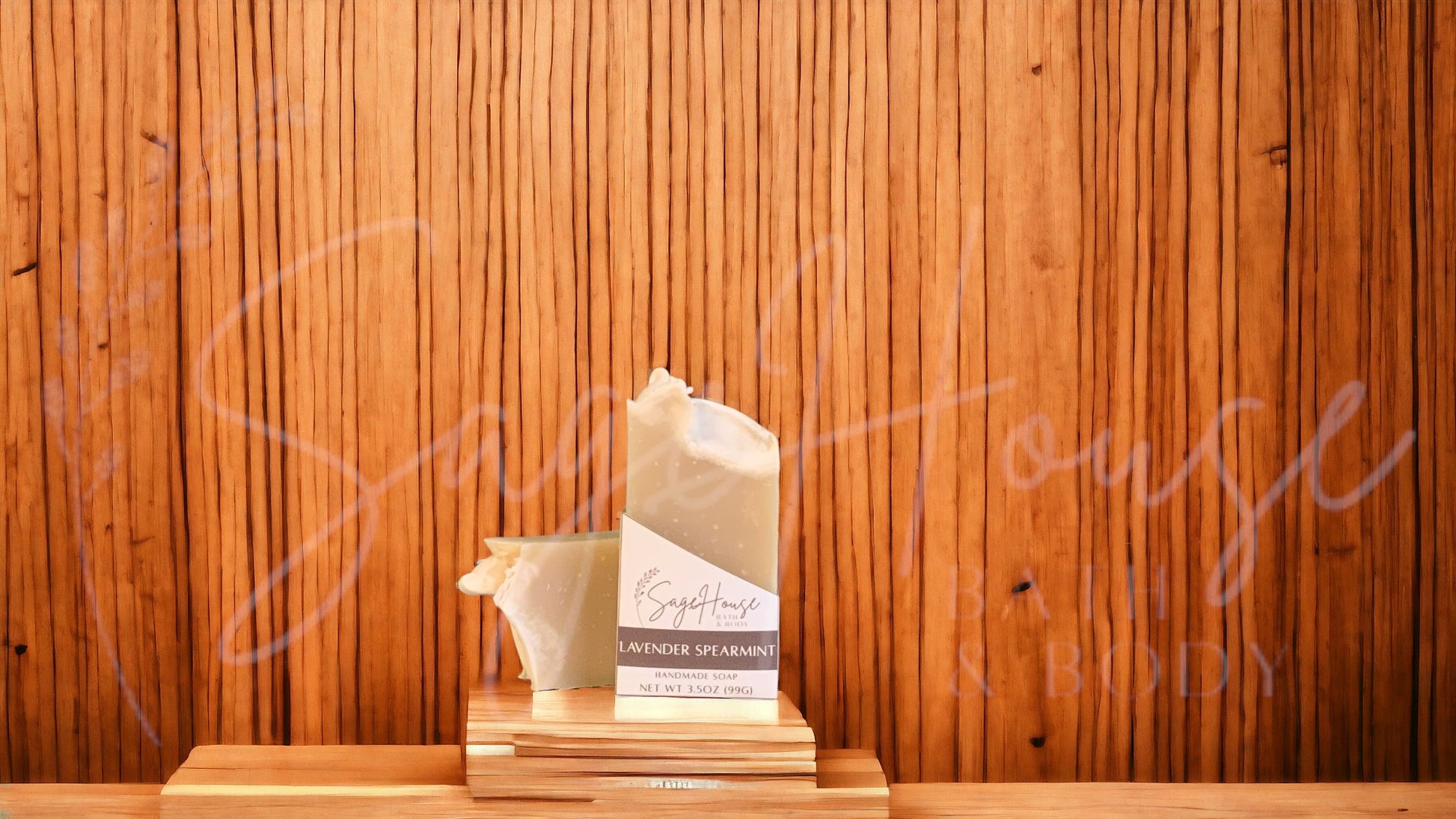 A tan bar of soap in a white labeled box, on a wood surface.