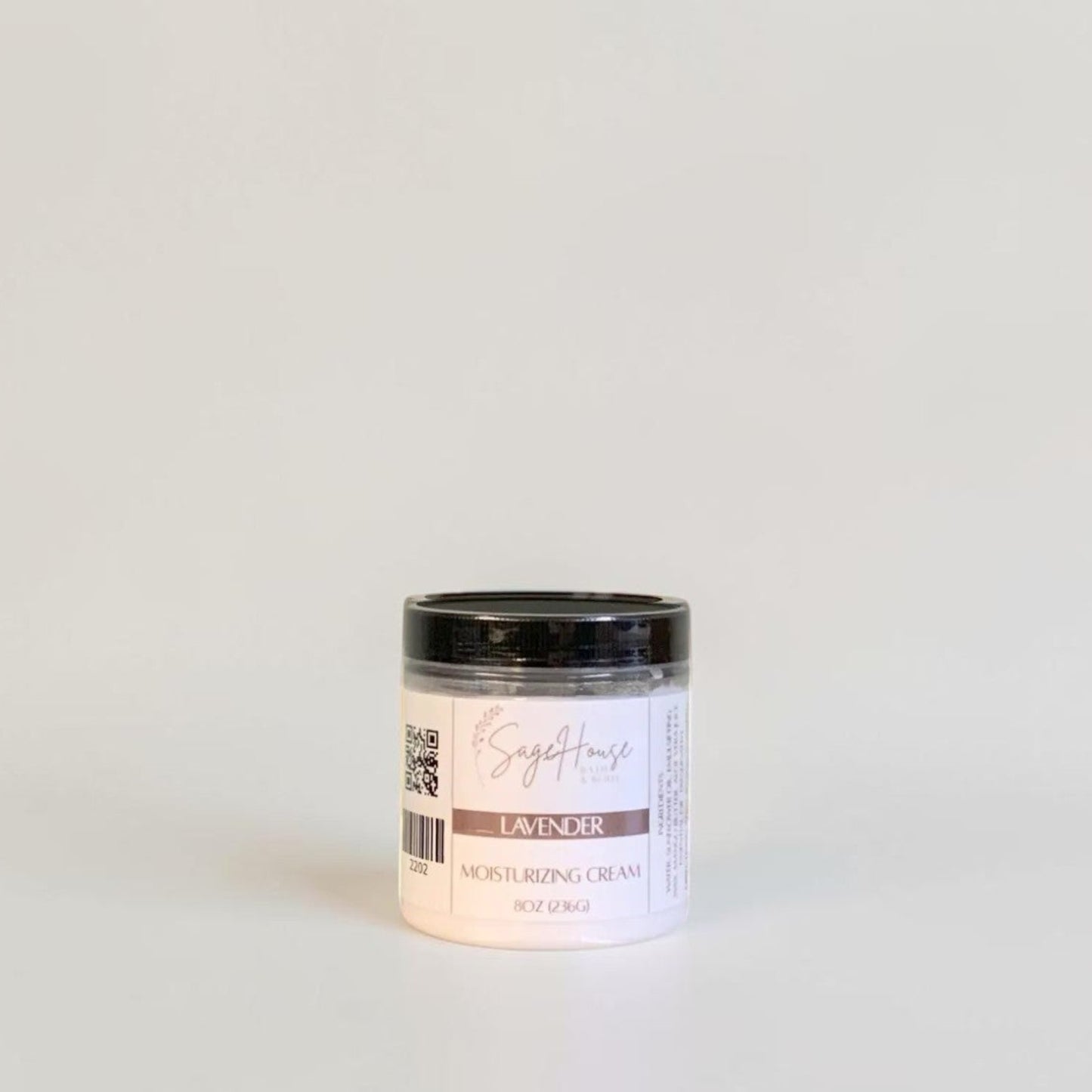 A labeled jar with a black lid. On a neutral background.