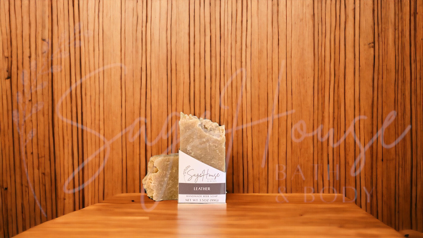 A tan bar of soap in a white labeled box, on a wood surface.