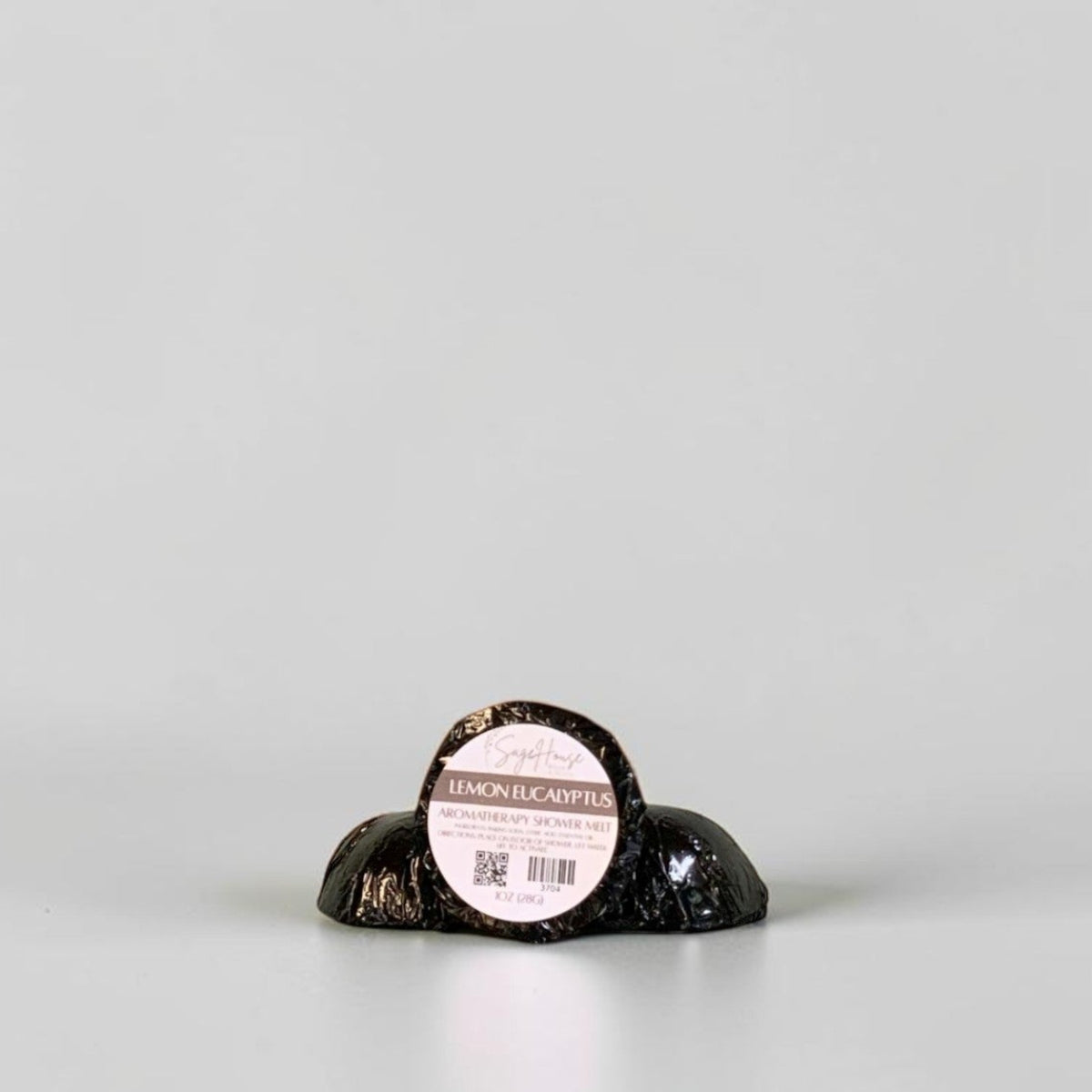 One labeled shower melt propped in front of 2 other shower melts. Sitting on a white background.