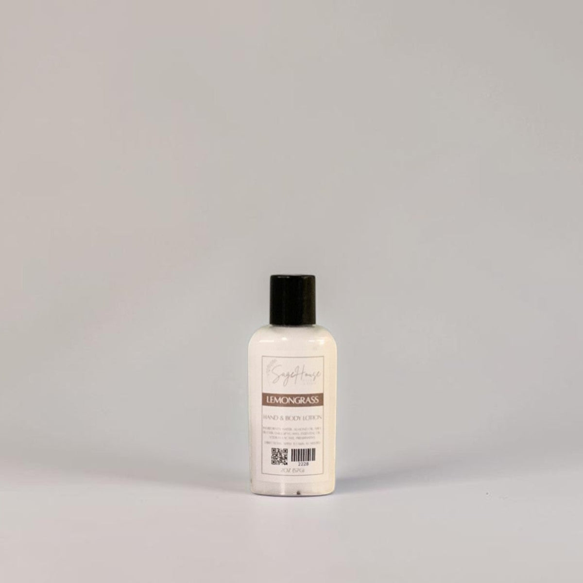 A small bottle of lotion with black cap and white label. On a white background.