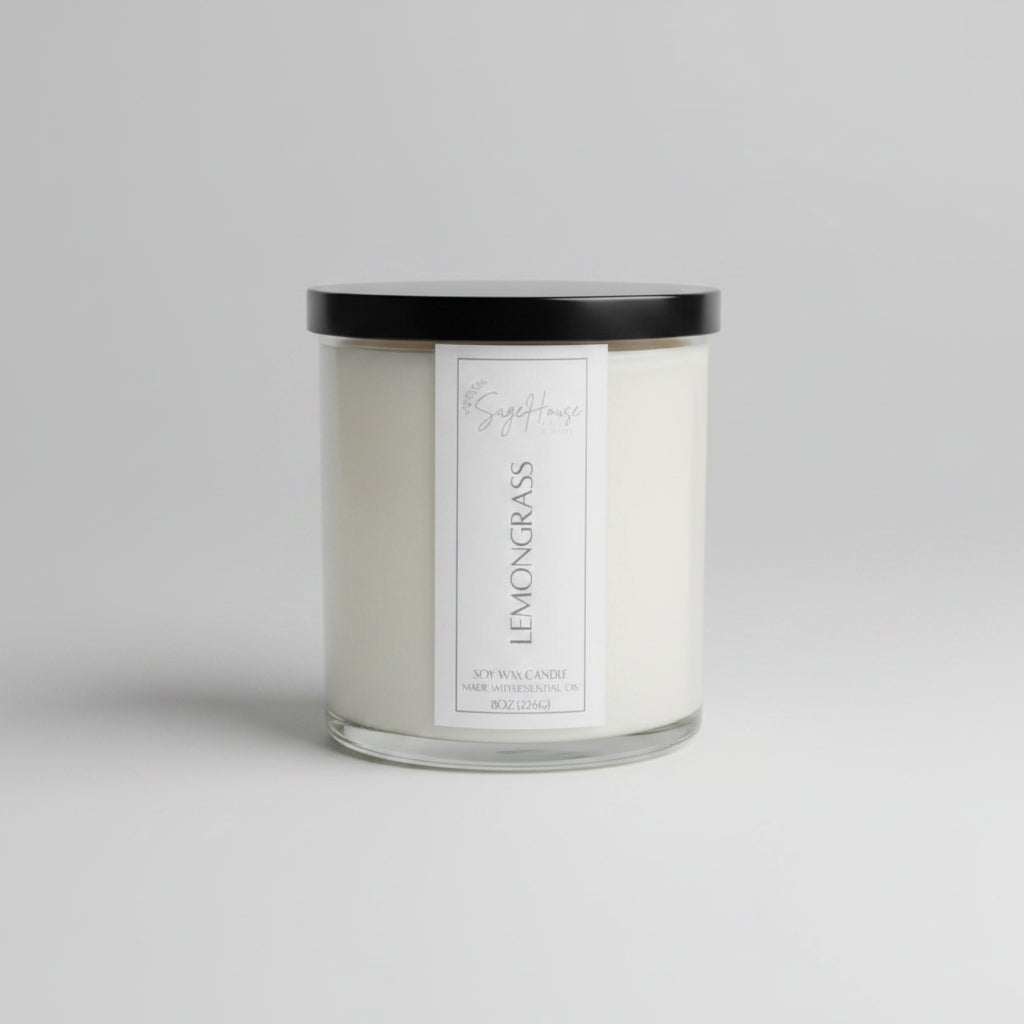A white soy wax candle in a clear container, placed on a neutral background.