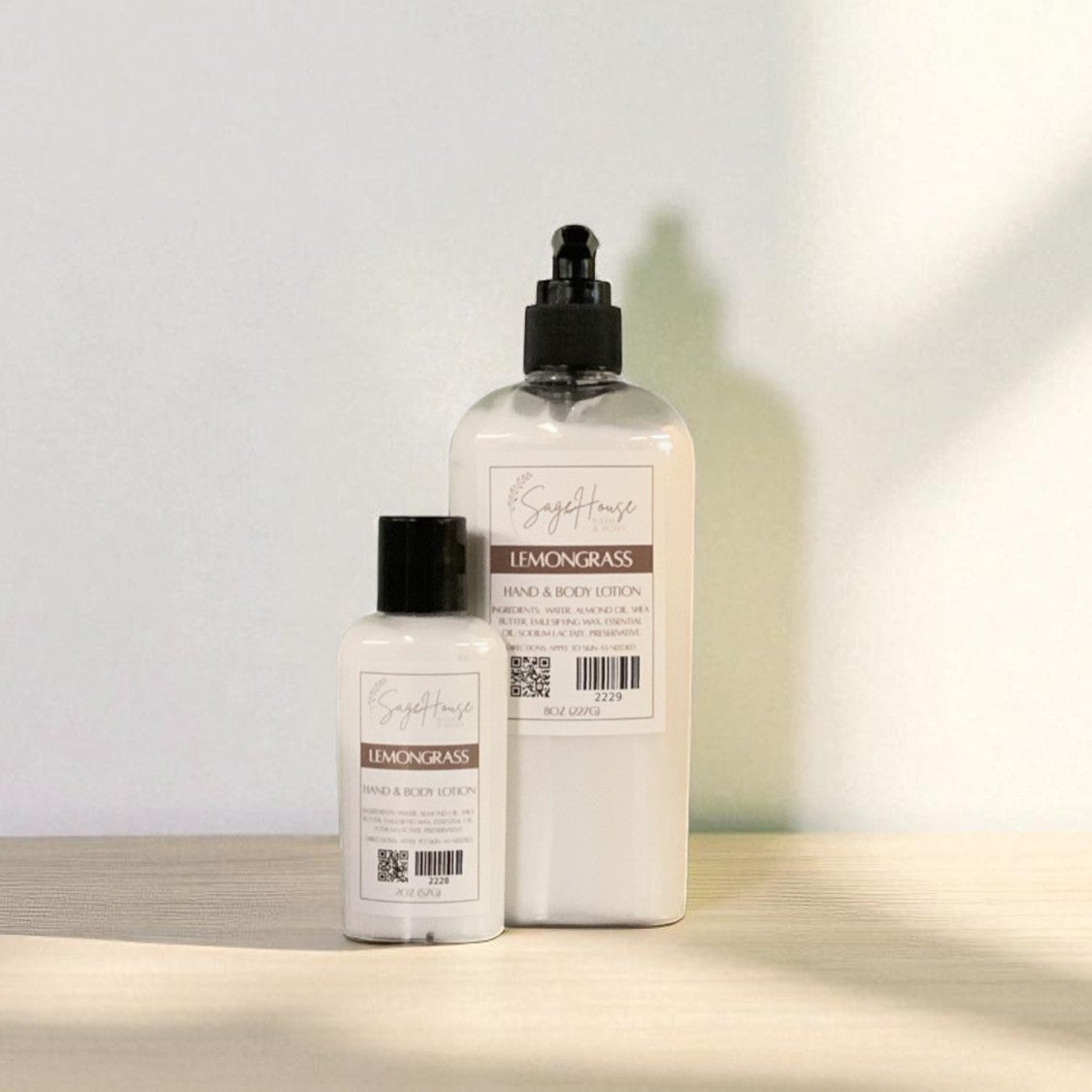 Two white bottles of lotion with black cap and black pump top on a light wooden surface with a blurred white background