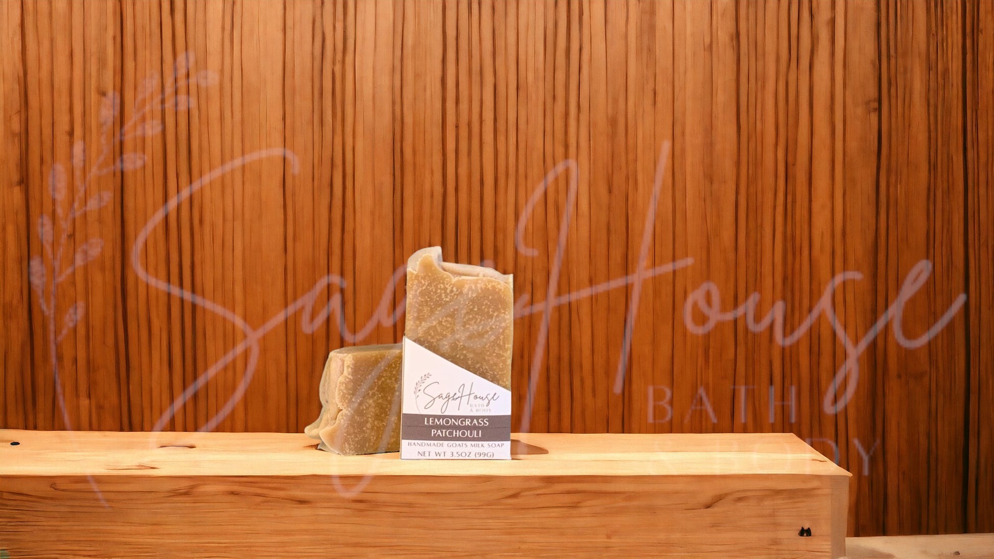 A tan bar of soap in a white labeled box, on a wood surface.