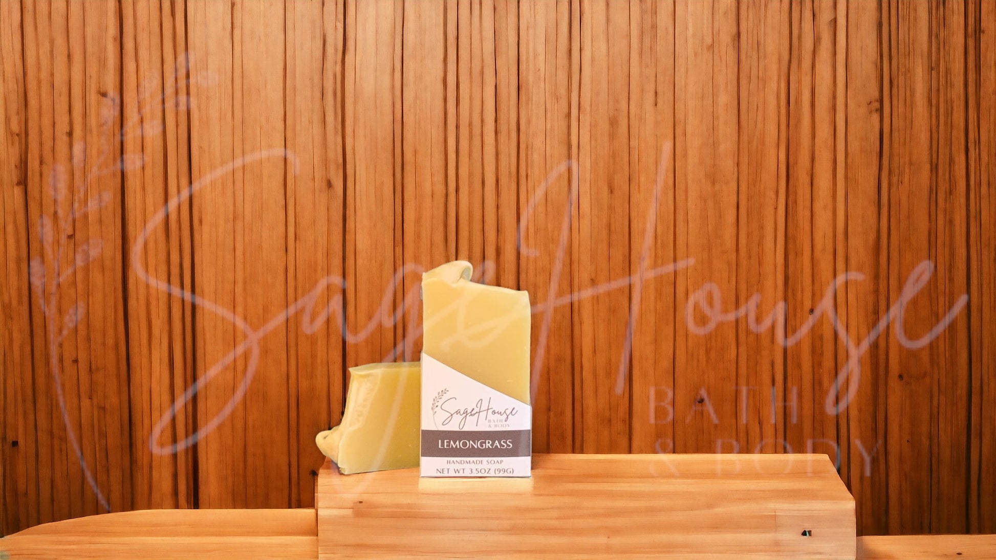 A yellow bar of soap in a white labeled box, on a wood surface.