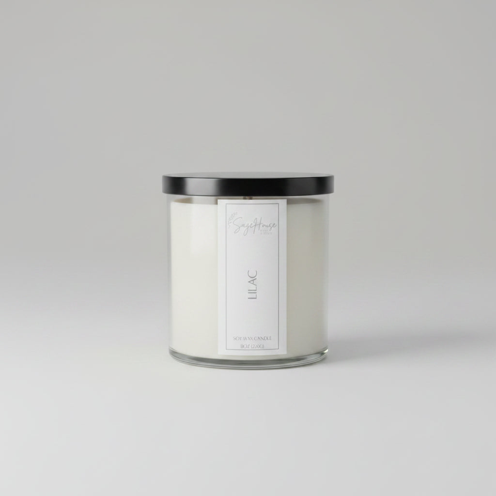 A white soy wax candle in a clear container, placed on a neutral background