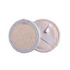 A round loofah pad on a white background