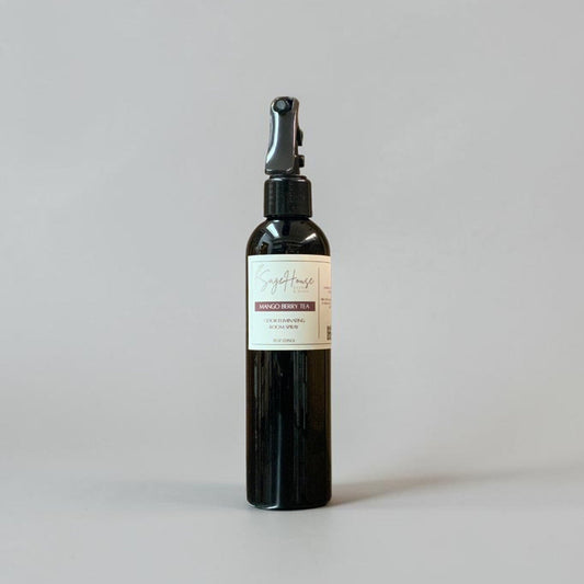 Black spray bottle with a label on a gray background