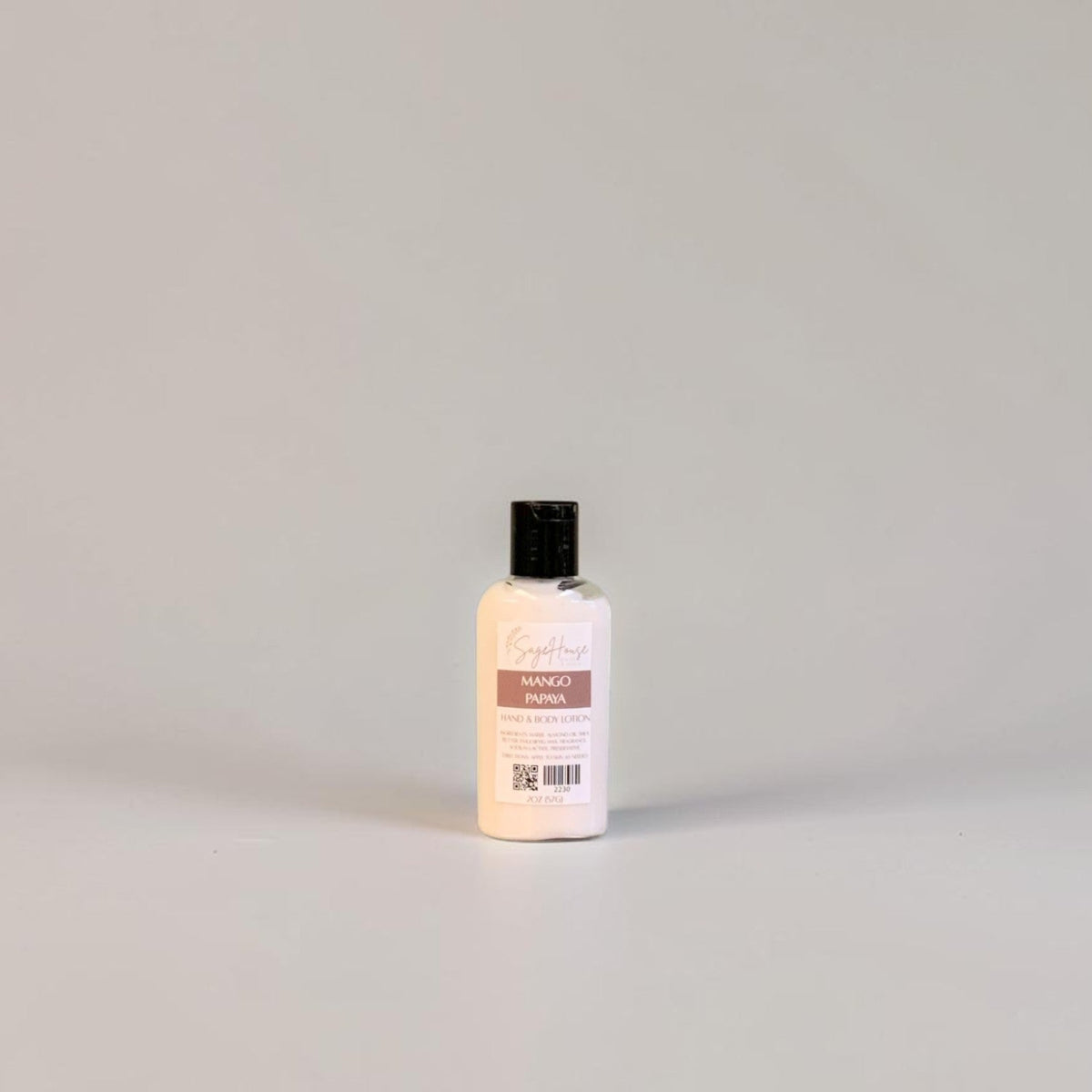 A small bottle of lotion with black cap and white label. On a white background.
