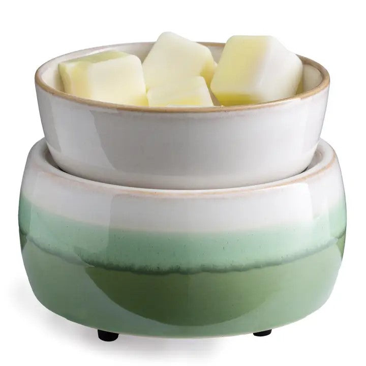 A two-tiered ceramic warmer with a matcha green and white color scheme, containing wax cubes on top
