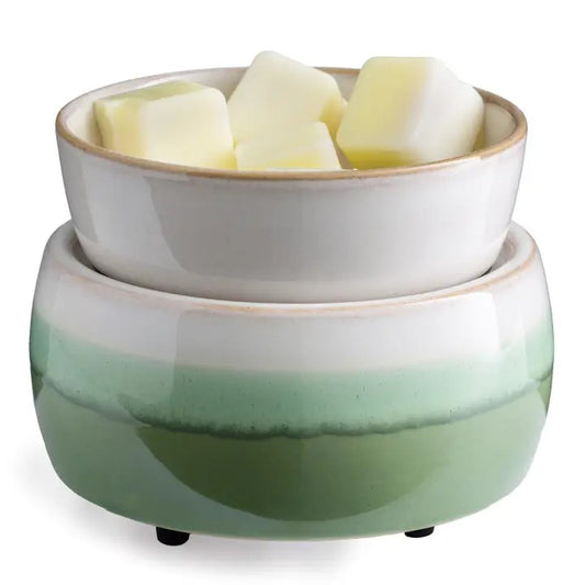 A two-tiered ceramic warmer with a matcha green and white color scheme, containing wax cubes on top